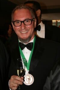 A photo of Miami chef Michael Schwartz wearing a James Beard Award.