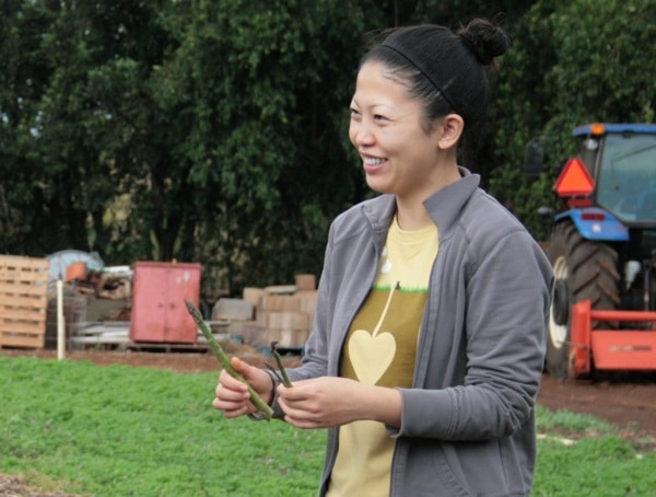 A photo of a smiling woman on a farm