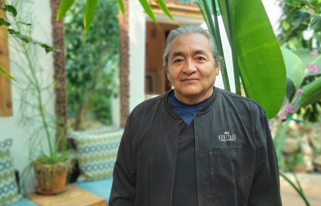 A man with grey hair smiling for the camera 